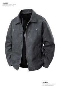 Detail of grey retro functional bomber jacket showing textured fabric and elastic hem