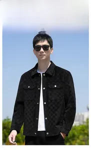 Detail of black suede checkered jacket featuring metal buttons and shirt-style collar