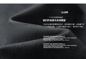 Close-up detail of high-density black woven jacket fabric showing rich texture and quality