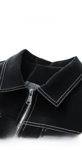 Detail of lapel collar and silver zipper on black leather jacket with contrast stitching