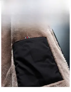 Macro detail of winter jacket featuring thick brown fleece lining and inner pocket