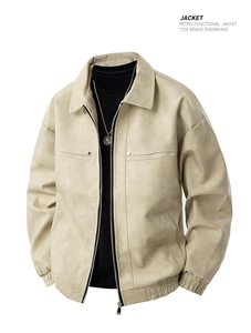 Detailed view of beige suede jacket featuring lapel collar and metal zipper pockets