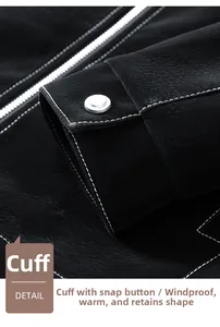 Close-up of black suede jacket sleeve cuffs with silver snap buttons and white stitching