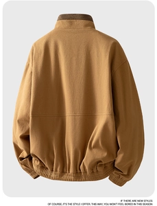 Macro shot of khaki cotton canvas jacket back featuring dual-color corduroy stand collar