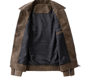 Detail view of brown suede jacket with metal zippers and smooth black polyester lining