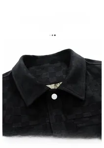 Detail showing fashion lapel design with checkered texture and white button on black jacket