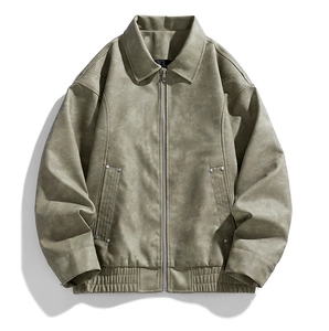 Detail view of sage green jacket with snowflake texture, metal zipper and ribbed hemline