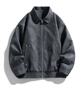 Detailed view of dark grey suede-like jacket with zip closure and rivet pocket design