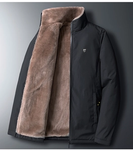 Detail of warm brown faux fur lining and black windproof fabric on men's winter jacket