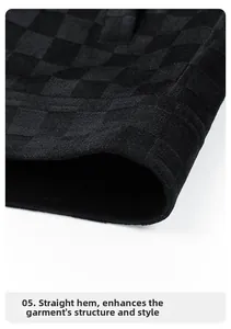 Macro detail of men's jacket showing black checkered texture and straight hem stitching