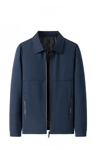Detailed close-up of dark blue men's winter jacket with zipper and elastic ribbed cuffs