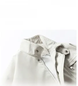 Detail of stand-up collar with zip and snap button on off-white chenille windproof jacket