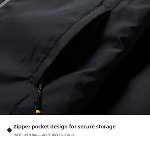 Detail of black outdoor jacket featuring a secure zipper pocket with a yellow puller