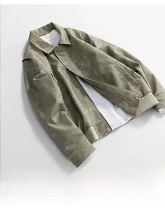 Detailed view of olive green faux leather jacket featuring ribbed cuffs and stitched seams