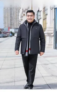 Close-up of middle-aged man in black winter jacket with grey plaid scarf in city setting