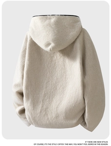 Close-up detail of oversized off-white faux fur hoodie showing plush texture and hood