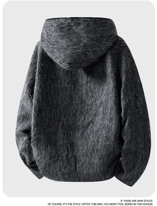 Macro detail of plush dark grey wool jacket featuring a soft texture and oversized hood back