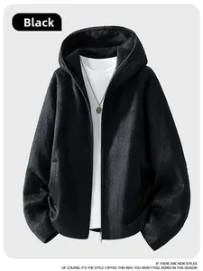 Detail of black hooded wool jacket with front metal zipper and textured fabric finish