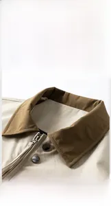 Close-up of contrast brown collar and metal zipper on khaki pilot jacket for men
