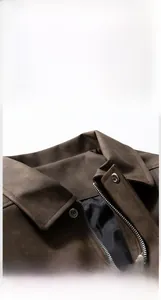 Detail view of the vintage brown jacket featuring silver zipper and collar texture