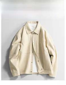 Detailed flat lay of an apricot cotton work jacket featuring chest pockets and metal buttons