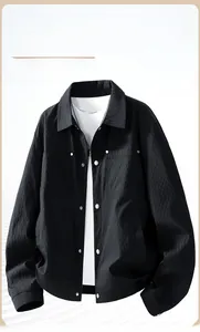 Detailed view of black jacket featuring 3D geometric texture and flap pockets