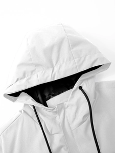 Close-up of white hooded jacket with black drawstrings and high collar design