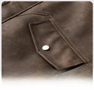 Detail of vintage brown PU leather jacket featuring asymmetric pocket and silver metal button