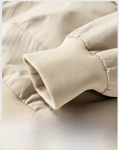 Detail shot of beige ribbed cuffs on a vintage aviator jacket with soft fabric texture