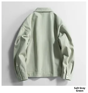 Detail of the back middle seam and metallic cuff buttons on a salt grey green jacket