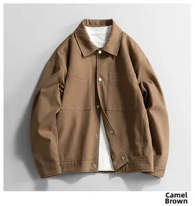 Detail of camel brown workwear jacket featuring symmetry large pockets and twill fabric