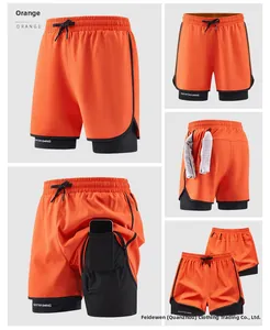 Detail view of 2-in-1 orange athletic shorts with black liner and hidden phone pocket