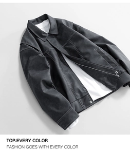 Detail view of dark grey faux leather jacket featuring contrast white stitching and metal zip