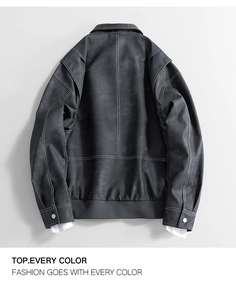 Macro detail of dark grey jacket featuring white contrast stitching and shoulder seam design
