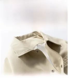Detail of classic khaki twill jacket collar with round metal snap buttons and smooth lining