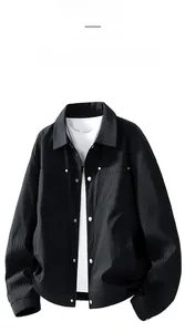 Detailed view of the black textured jacket's lapel with metal zipper and snap buttons