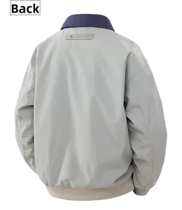 Back view of gray pilot jacket featuring navy collar and beige ribbed hem detail