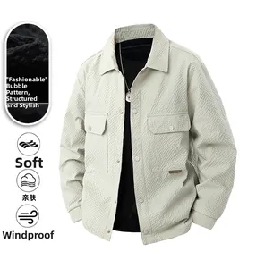 Detail of seersucker beige jacket with silver snap buttons and double chest pockets