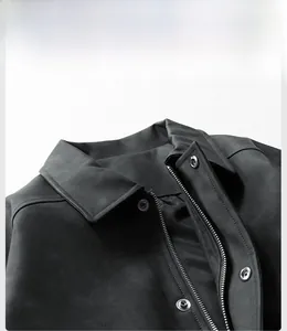 Detail view of black vintage faux leather jacket with metal snap buttons and zipper