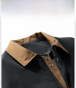 Detail of contrast turn-down collar with metal snap buttons and zipper on aviator jacket