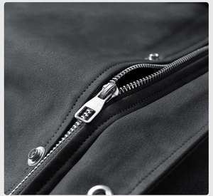 Detailed macro view of silver metal zipper and stitching on black PU leather jacket