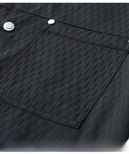 Detail of black men jacket showing vertical pleated texture and silver metal buttons