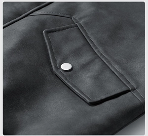 Detailed close-up of dark gray PU leather jacket showing fine texture and silver metal button