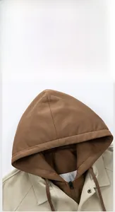 Detailed close-up of khaki faux two-piece hooded jacket with brown inner layer and drawstring