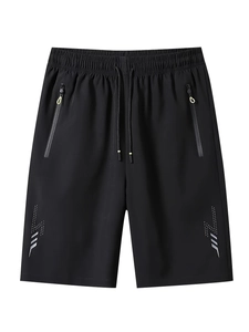 Detail of black sports shorts featuring zipper pockets, drawstring waist and reflective strips