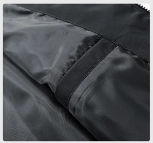 Detail shot of black synthetic lining fabric with twill texture and stitching for jacket