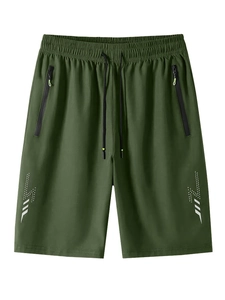 Detail of olive green athletic shorts with elastic drawstring waist and zippered pockets