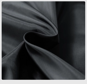 Macro shot of high-density black woven fabric texture on a vintage pilot jacket