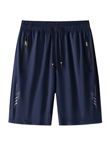 Detail of navy blue sports shorts with zipper pockets and reflective lightning print
