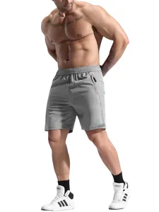 Detail of grey quick-dry sports shorts featuring secure zipper pockets and reflective stripes
